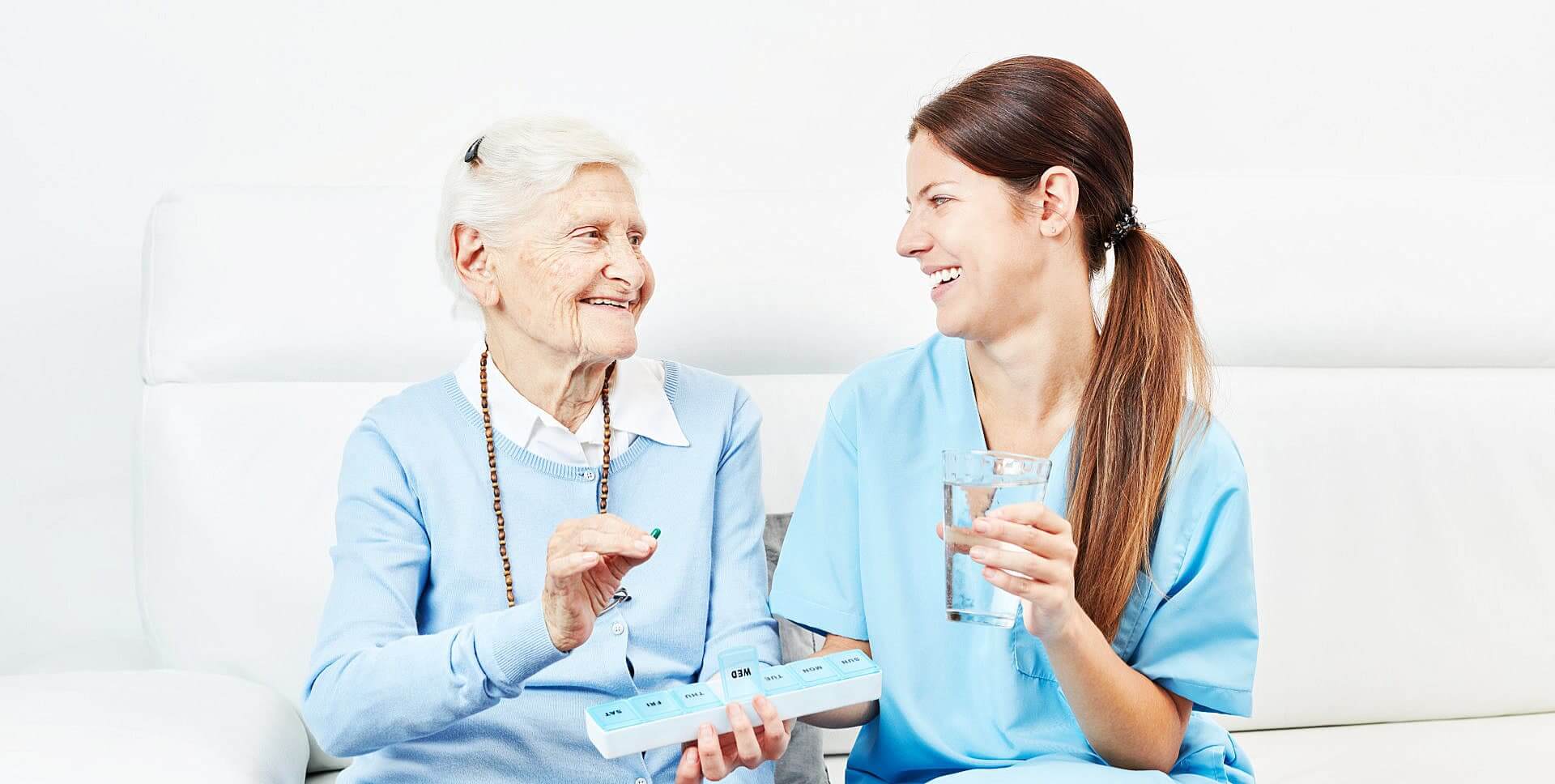caregiver and senior woman smiling